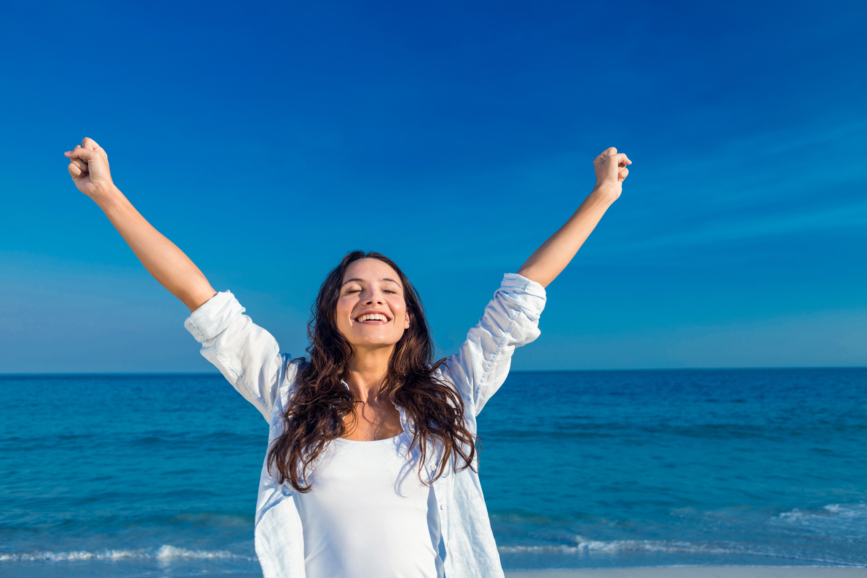 Happy woman smiling at the beach